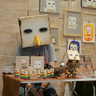 A Korean illustrator dressed up as the main character of his artworks - some kind of boxy bird.
