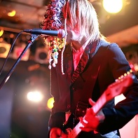 Even the supporting guitar player was wearing colorful accessories with his black suit.