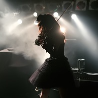 Rose Noire's female violin player Jill in backlight.