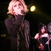 The vocalist Louie of Rose Noire dressed in Elegant Gothic Aristocrat fashion.