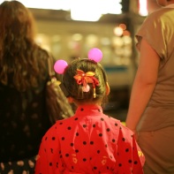 A young girl with her mother on her way home at the Shimokita crossing after the awa odori.