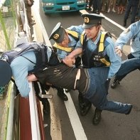 An anti-nuke activist desperately tries to keep the police from arresting him.