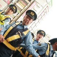Japanese policemen forming lines to to contain the rally on its route.