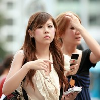 Two Shibuya girls in elegant Japanese fashion looking around.