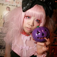 Another costumed goth girl with a pink wig and blue contacts.