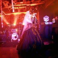 Japanese goth band Remnant on stage: guitarist Takmi, singer Marie and narrator Rober_tJ.