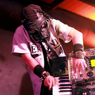 The keyboard player Tsuyoshi of Hernia 44 wearing a gas mask during the concert.