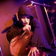 Vanished Empire's Dee Lee singing in his black cowl.