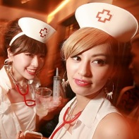 Two beautiful Japanese girls in matching nurse costumes.