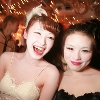 Two Japanese girls cosplaying in black and white Black Swan costumes.