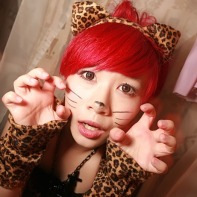 A cute Japanese girl with red hair in a cat costume.
