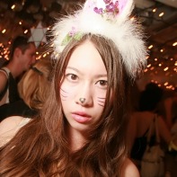 A long-haired cute Japanese girl with some cat make-up.