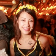 A smiling Japanese girl wearing a wasp costume.