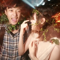 A Japanese couple with ivy wreaths dancing in the Trump Room club.
