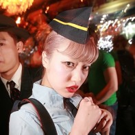 Japanese girl in an old-school flight attendant's costume at the Noir Halloween party.