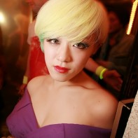 Blonde Japanese girl in a purple kimono dress.
