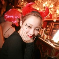 Smiling Japanese girl with devil's horns in the Trump Room.
