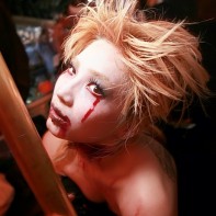 Scary blonde Japanese girl portrait next to the brass dance pole.