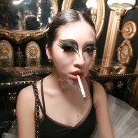 Japanese girl in a Black Swan ballerina costume smoking.