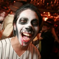 Laughing Japanese guy with skullhead make-up.
