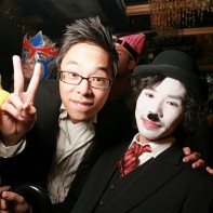 Japanese guy next to a Japanese Charlie Chaplin giving the v-sign.