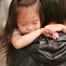 Small girl being carried by her father in Shibuya